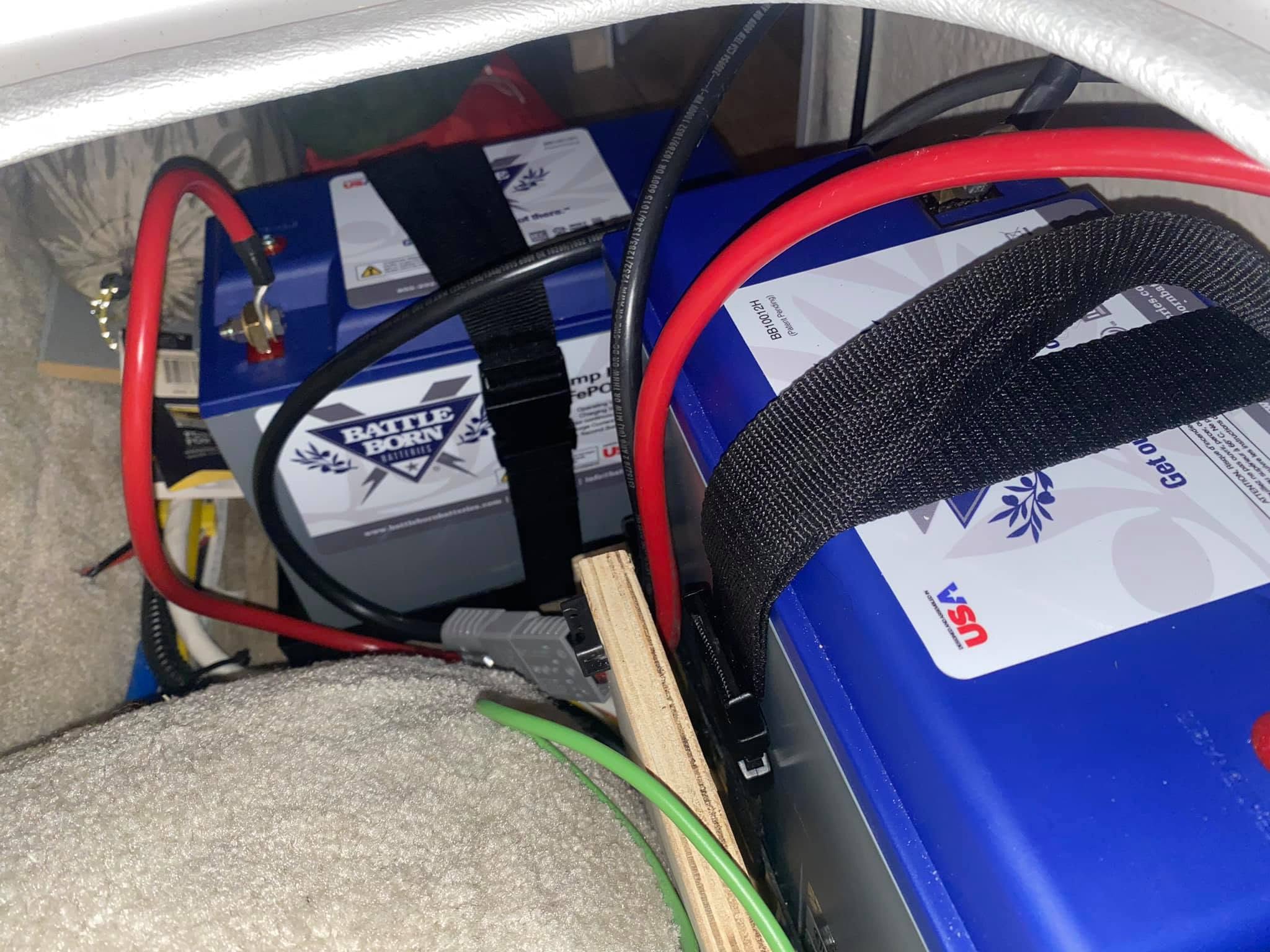 Pair of Battle Born heated batteries and protected wiring beneath the bunks